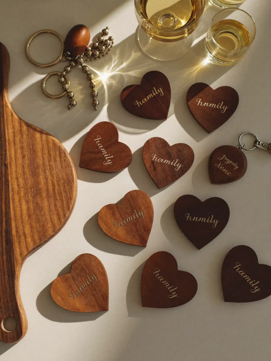 Flat-lay collection of laser engraved wooden gifts including cutting board, hearts, coasters and keychains